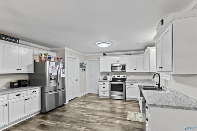 3559 County Road 1570, Baileyton, AL 35019 - kitchen featuring appliances with stainless steel finishes, wood finished floors, light countertops, and white cabinetry