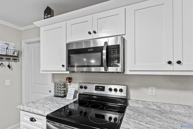 3559 County Road 1570, Baileyton, AL 35019 - kitchen with crown molding, white cabinets, appliances with stainless steel finishes, and light stone counters
