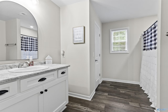 3559 County Road 1570, Baileyton, AL 35019 - bathroom with a shower with shower curtain, vanity, baseboards, visible vents, and wood finished floors
