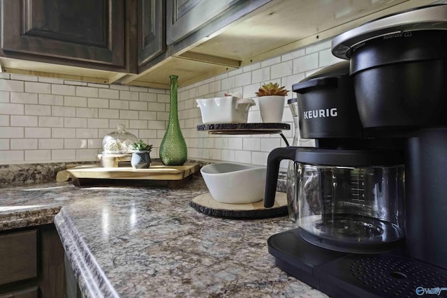 details featuring dark brown cabinetry and decorative backsplash