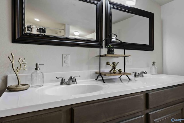 bathroom with a sink and double vanity