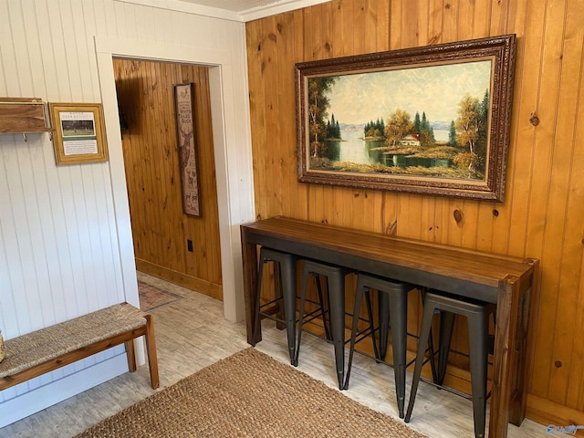 corridor with wood walls and wood finished floors