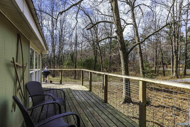 wooden terrace with a view of trees