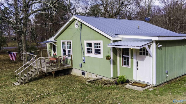 back of house featuring metal roof and crawl space