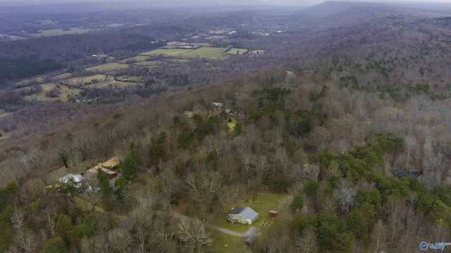 drone / aerial view with a wooded view