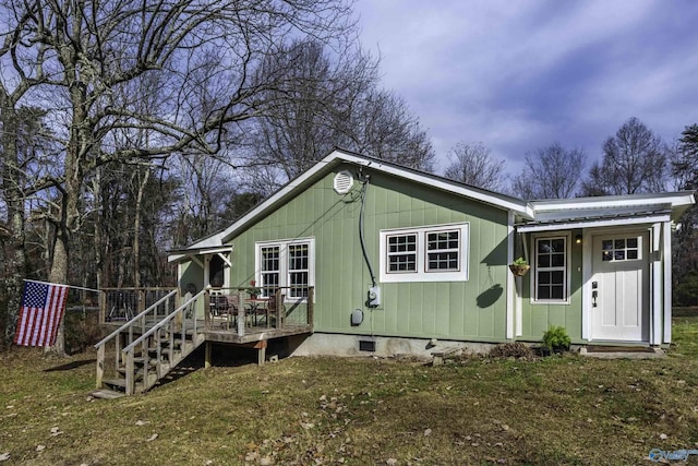 view of front of house with a front lawn, crawl space, and a wooden deck