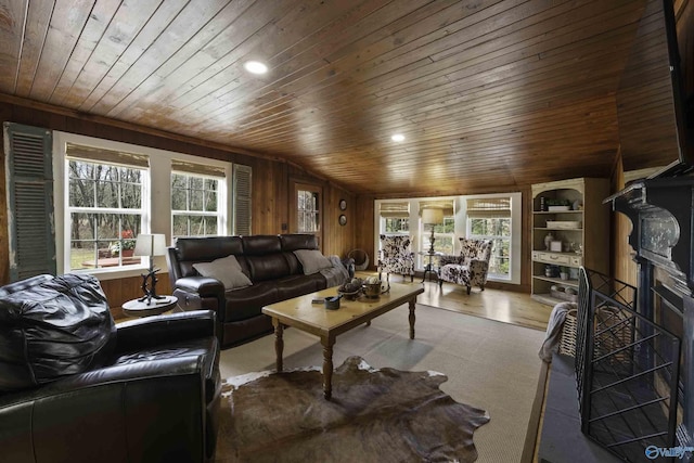 living area with wooden ceiling, wood walls, a fireplace, wood finished floors, and vaulted ceiling