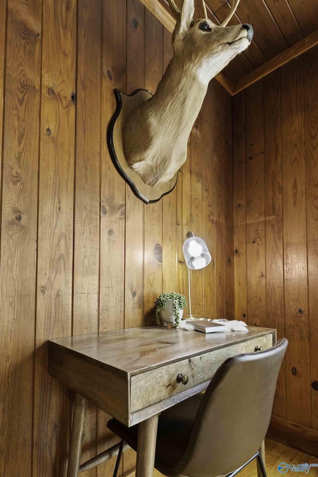 dining room with wood ceiling, wooden walls, and wood finished floors