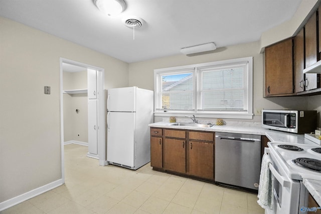 kitchen with visible vents, light countertops, a sink, and appliances with stainless steel finishes