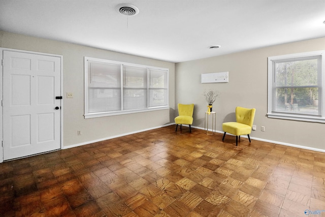 living area featuring visible vents and baseboards