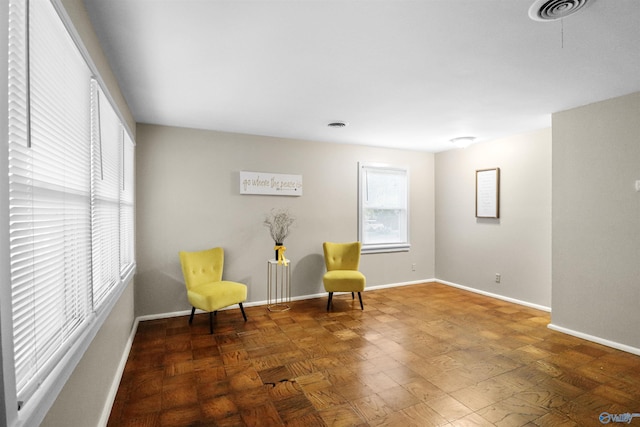 living area with visible vents and baseboards
