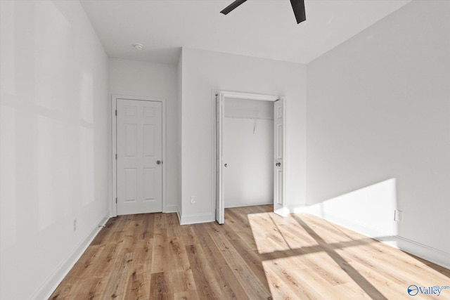 unfurnished bedroom with ceiling fan, light hardwood / wood-style floors, and a closet