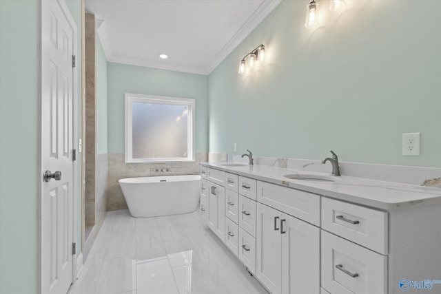 bathroom featuring a washtub, vanity, and ornamental molding