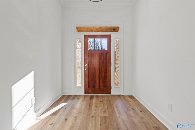 entrance foyer featuring crown molding and light hardwood / wood-style flooring