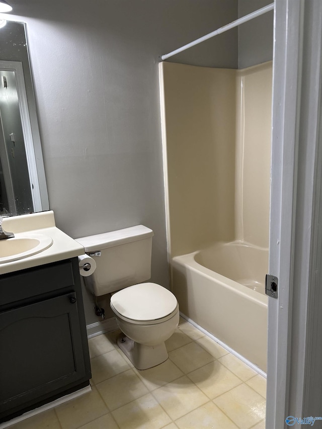 bathroom featuring washtub / shower combination, tile patterned flooring, vanity, and toilet