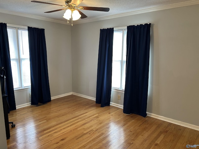 spare room featuring a textured ceiling, plenty of natural light, and light wood-style flooring