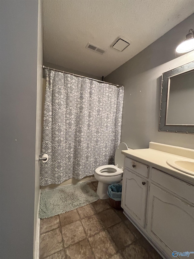 full bathroom with visible vents, toilet, stone finish flooring, a textured ceiling, and vanity