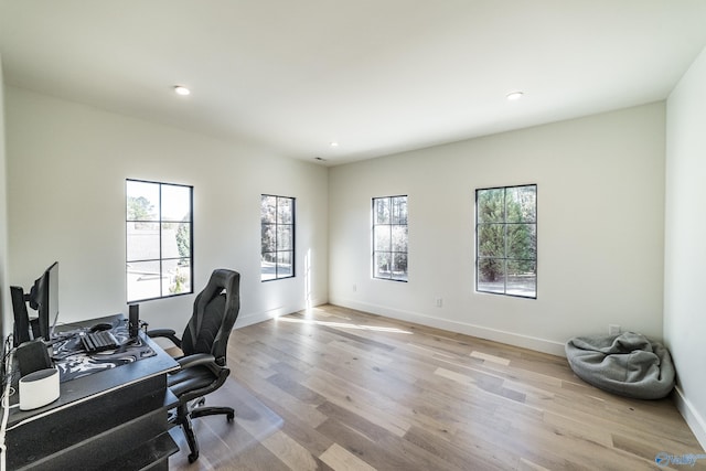 office area with light hardwood / wood-style floors