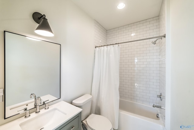 full bathroom with vanity, shower / bath combo, and toilet