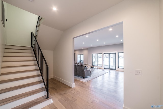 staircase with hardwood / wood-style floors