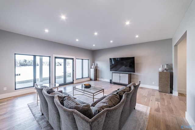 living room featuring french doors and light hardwood / wood-style flooring