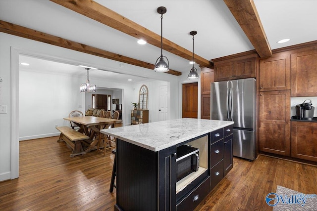 kitchen with dark wood-style flooring, hanging light fixtures, beamed ceiling, freestanding refrigerator, and recessed lighting