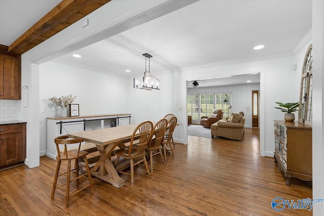 dining area featuring crown molding, recessed lighting, and wood finished floors