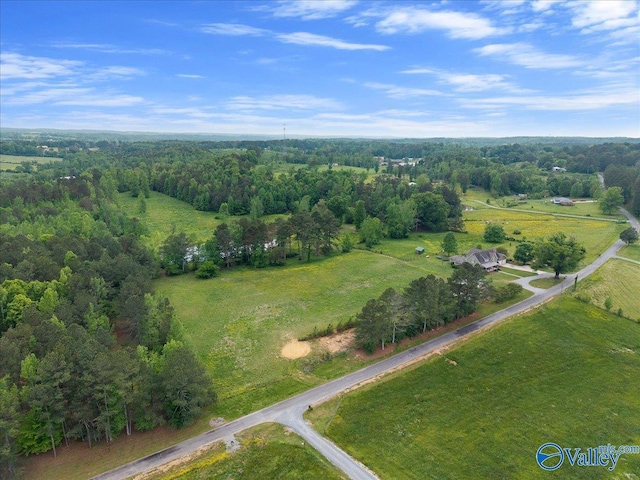 birds eye view of property with a wooded view