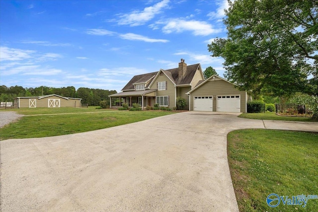 craftsman-style house featuring driveway, a chimney, and a front lawn