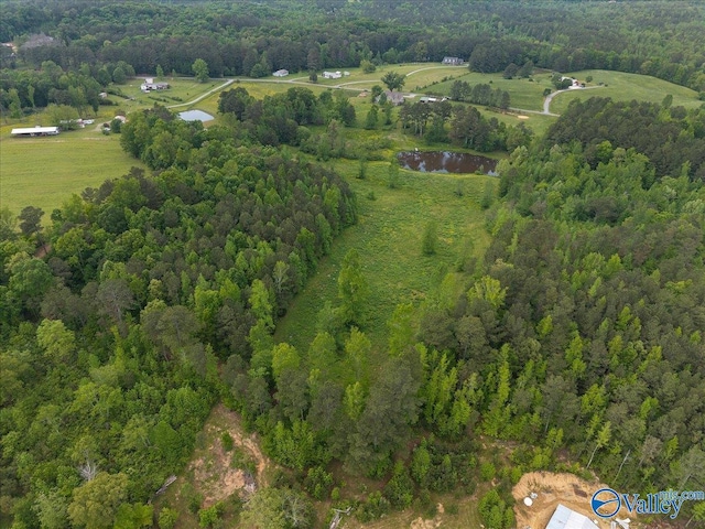 drone / aerial view with a wooded view
