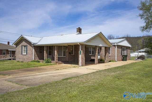 514 W St, Scottsboro, AL 35768 - ranch-style home with driveway, a front yard, a chimney, brick siding, and metal roof