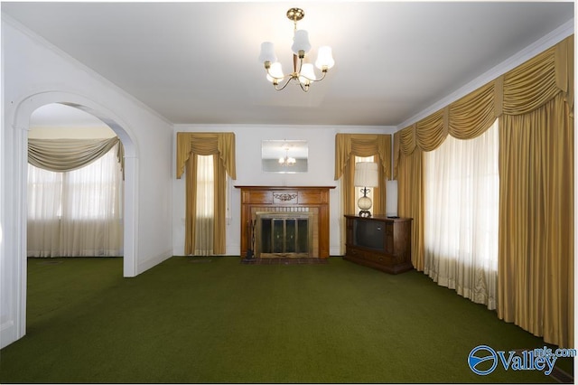514 W St, Scottsboro, AL 35768 - unfurnished living room featuring a notable chandelier, carpet, a fireplace, arched walkways, and ornamental molding