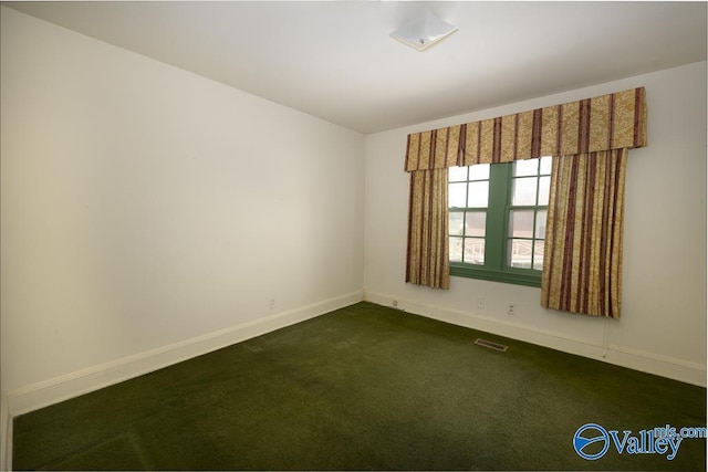 514 W St, Scottsboro, AL 35768 - empty room featuring baseboards, visible vents, and dark colored carpet