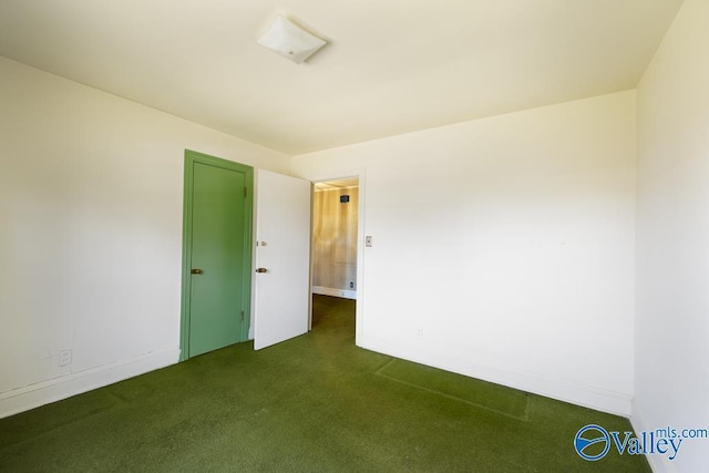 514 W St, Scottsboro, AL 35768 - empty room with baseboards and dark carpet