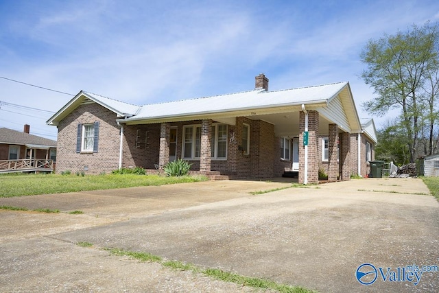 514 W St, Scottsboro, AL 35768 - ranch-style home featuring brick siding, a chimney, metal roof, and concrete driveway