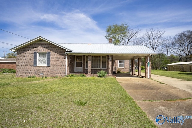 514 W St, Scottsboro, AL 35768 - view of front of home featuring brick siding, a front yard, and a carport