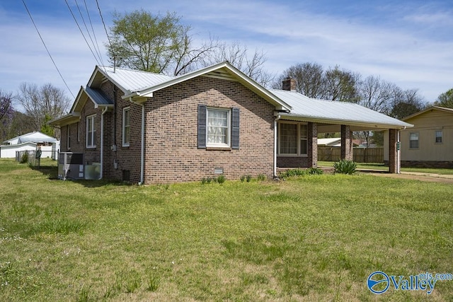 514 W St, Scottsboro, AL 35768 - single story home featuring brick siding, a front yard, an attached carport, and a chimney