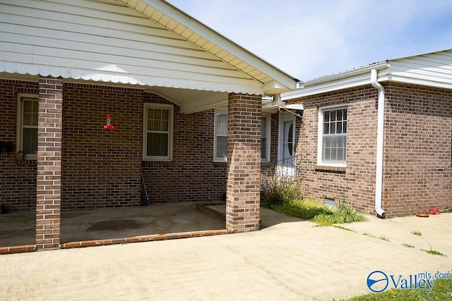 514 W St, Scottsboro, AL 35768 - view of exterior entry with brick siding and a patio area