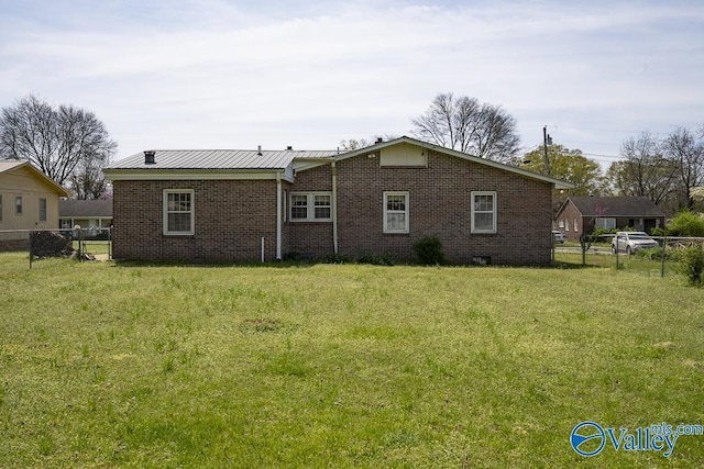 514 W St, Scottsboro, AL 35768 - rear view of property with a lawn, brick siding, fence, and metal roof