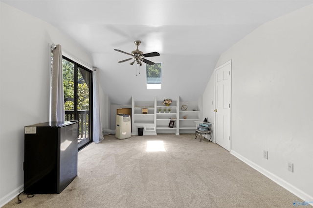 bonus room with vaulted ceiling, a ceiling fan, carpet floors, baseboards, and a skylight