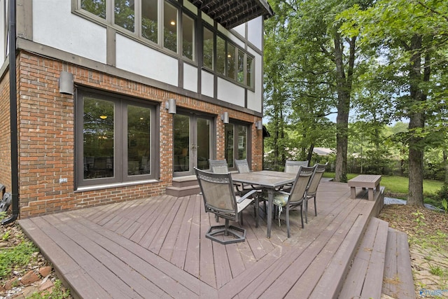 wooden deck with french doors and outdoor dining space