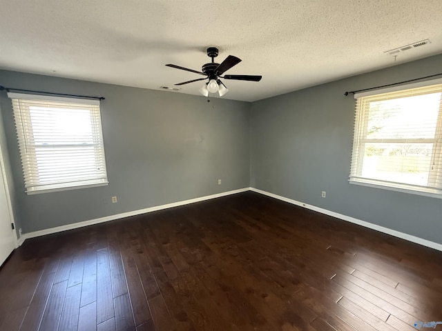 1903 Garner St, Scottsboro, AL 35769 - spare room with visible vents, baseboards, dark wood-style flooring, ceiling fan, and a textured ceiling