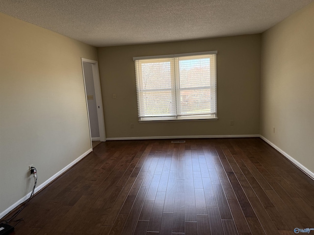 1903 Garner St, Scottsboro, AL 35769 - empty room featuring dark wood-type flooring, a textured ceiling, and baseboards