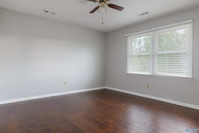 1903 Garner St, Scottsboro, AL 35769 - spare room with baseboards, dark wood finished floors, and visible vents