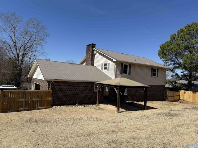 1903 Garner St, Scottsboro, AL 35769 - rear view of house with a patio, a gazebo, fence, and brick siding