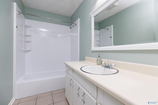 1903 Garner St, Scottsboro, AL 35769 - bathroom with tile patterned floors, vanity, bathtub / shower combination, and a textured ceiling