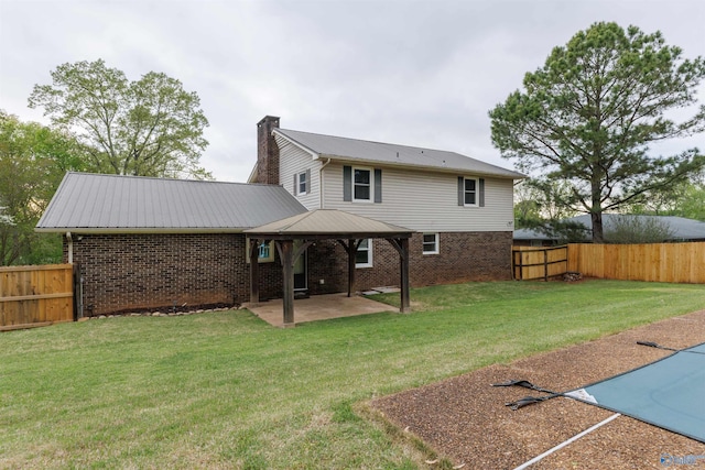 1903 Garner St, Scottsboro, AL 35769 - back of house featuring a chimney, a patio area, a fenced backyard, and a yard