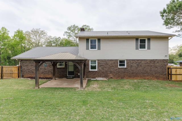 1903 Garner St, Scottsboro, AL 35769 - back of house featuring a chimney, a patio area, brick siding, a fenced backyard, and a yard