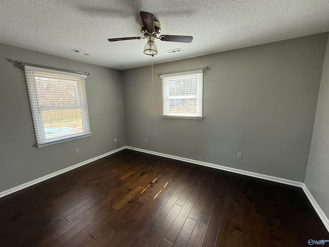 1903 Garner St, Scottsboro, AL 35769 - unfurnished room with baseboards, dark wood finished floors, a textured ceiling, visible vents, and ceiling fan