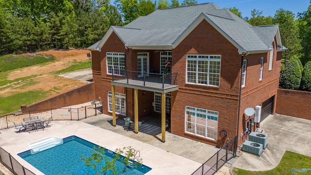 back of house with french doors, a patio, brick siding, and fence